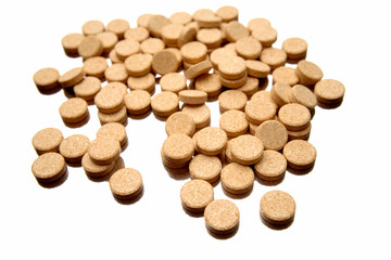 Vitamin C tablets over white background