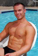 Muscular man by a pool