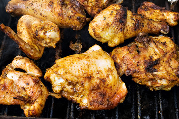 Closeup of chicken meat on barbecue grill with selective focus