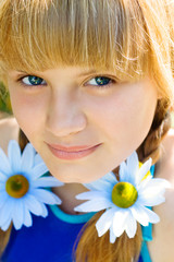the kid close up with camomiles