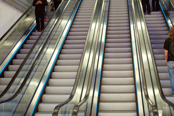 people on escalators in a department store