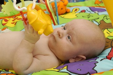 Small baby boy with toys