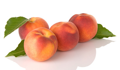 Four Fresh Peaches With Leaves