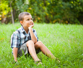 Cute kid sitting in grass