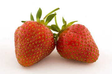 Two strawberries set against a white background