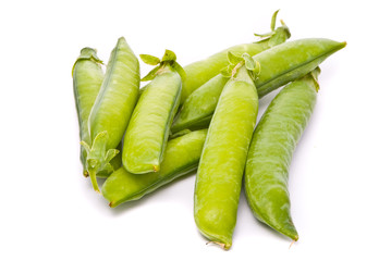 Pods of fresh green peas on a white background
