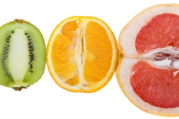 Fresh grapefruit, orange and kiwi isolated on white background