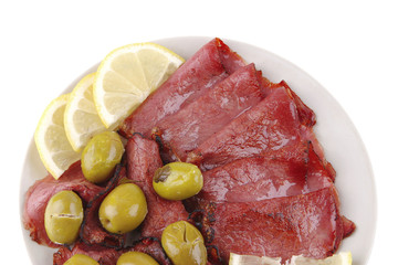 sliced served sausage with raw lemon