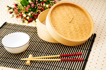 Chopsticks and bowl on the bamboo mat