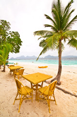 Obraz na płótnie Canvas Beach Table under Palm