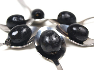 Black olives in spoons