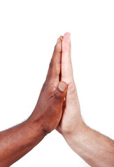 Two hands touching, black and white on background