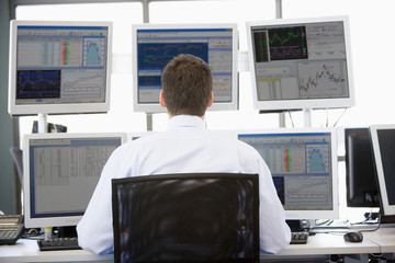 Stock Trader Looking At Multiple Monitors - obrazy, fototapety, plakaty