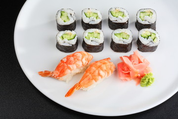 Japanese sushi set with shrimps and cucumber and avacado rolls