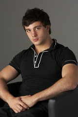 Studio Portrait Of Smiling Teenage Boy