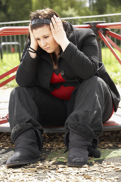 Young Woman Sitting In Playground