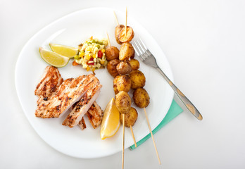 Crispy potatoes with a skewer of chicken steak