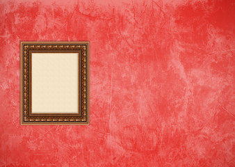 Grunge red stucco wall with empty picture frame