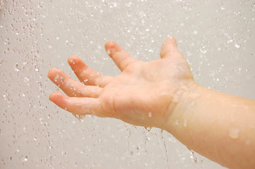 Baby hand with running water