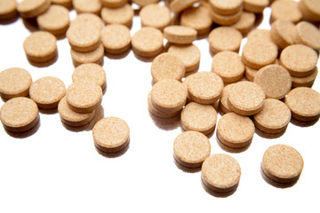 Vitamin C tablets on white background