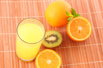 Oranges and juice on brown background