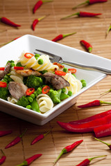 pasta with green vegetables and poultry meat