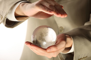 businessman holding mini globe