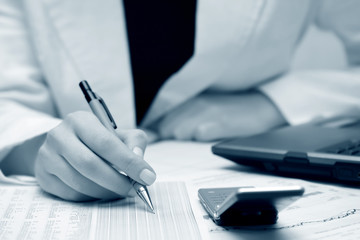 Businesswoman working with financial reports.