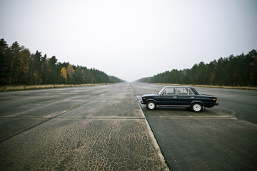 Fototapeta na wymiar lonely old car on an airstrip