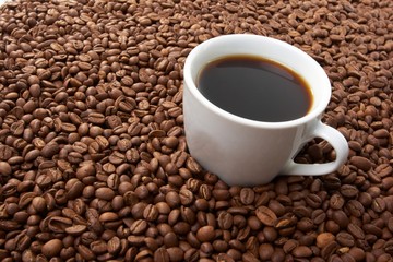 Cup with coffee, costing on coffee grain