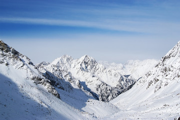 Fototapeta na wymiar Clear blue sky in winter mountains above the peaks