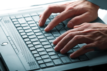 Fototapeta na wymiar male hands typing on a laptop
