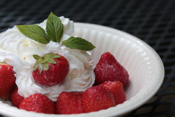 strawberries with cream, decorated with mint leaves