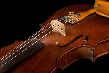 Old violin on black background