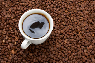 Cup with coffee, costing on coffee grain