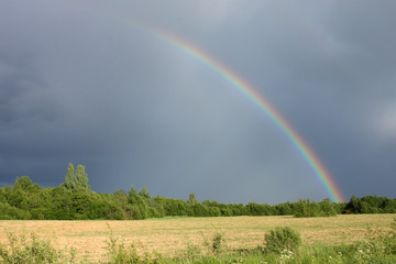 Rainbow between storm and sun