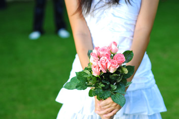A Lady Holding A Bouquet Of Pink Roses