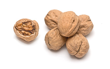Cracked walnut and pile of walnuts isolated on white background