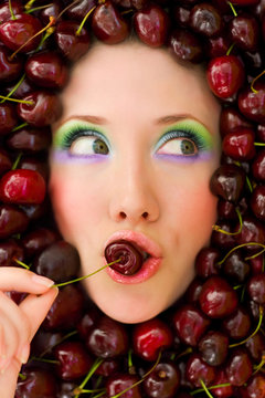 Beautiful Woman Face In A Sweet Cherry