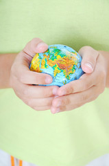 Boy holding the planet earth