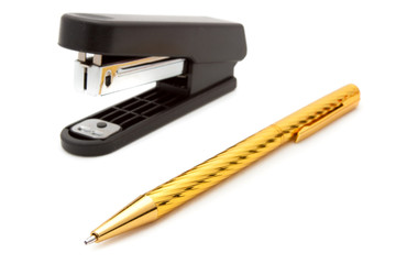 Stapler and pen isolated on white