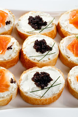 Mini sandwiches - bagel with cream cheese, salmon, caviar