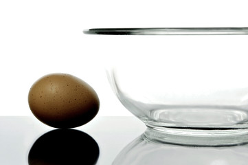 An egg and a glass bowl isolated and backlit