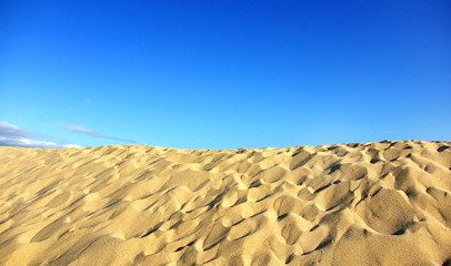 Texture of sand and blue sky.