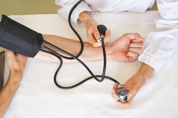 doctor measures pressure in the patient