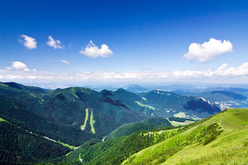 Fototapeta premium Mountain-ridge and blue sky with white clouds