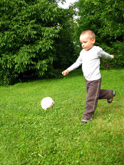 Little boy play football