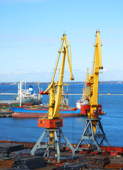 Two yellow lifting cranes