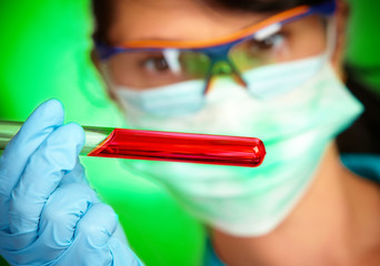 scientist in laboratory with test tubes