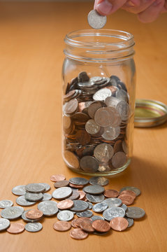 Putting coins in jar